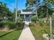 Beautiful two-story home featuring a well-manicured lawn, lush greenery, and a welcoming walkway at 206 S Riverside Dr, Edgewater, FL 32132