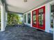 Inviting front porch with rocking chairs and large windows, offering a comfortable and relaxing outdoor space at 206 S Riverside Dr, Edgewater, FL 32132