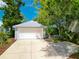The detached garage with driveway provides parking and storage for the home at 206 S Riverside Dr, Edgewater, FL 32132