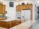 Bright kitchen features wooden cabinets, stainless appliances, and white countertops with a stone backsplash at 206 S Riverside Dr, Edgewater, FL 32132