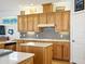 Updated kitchen with wood cabinetry, granite countertops, stainless appliances, and an island at 206 S Riverside Dr, Edgewater, FL 32132