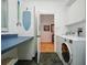 Functional laundry room featuring a countertop, washer, dryer, and storage cabinets at 206 S Riverside Dr, Edgewater, FL 32132
