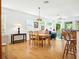 Open-concept living space connecting dining and living areas, featuring hardwood floors and natural light at 206 S Riverside Dr, Edgewater, FL 32132