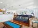 Open-concept living area with a comfortable couch, hardwood floors, and a view of the dining area and staircase at 206 S Riverside Dr, Edgewater, FL 32132