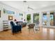 Bright living room with beautiful hardwood floors, ceiling fan, and lots of natural light at 206 S Riverside Dr, Edgewater, FL 32132