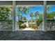 Inviting covered patio offering serene views of the meticulously landscaped backyard and blue skies at 206 S Riverside Dr, Edgewater, FL 32132