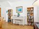 Cozy piano room with a white piano, built-in bookshelves, and natural light at 206 S Riverside Dr, Edgewater, FL 32132