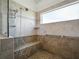 Large tiled shower with built-in bench and handrails at 206 S Riverside Dr, Edgewater, FL 32132