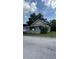 Charming one-story home featuring a covered front porch and mature landscaping at 215 Alma Ct, New Smyrna Beach, FL 32168