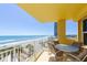 Condo balcony with seating and stunning ocean views for relaxing and enjoying the beach breezes at 2300 N Atlantic Ave # 203, Daytona Beach, FL 32118