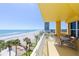 Charming condo balcony with seating and a stunning ocean view, perfect for relaxation and coastal living at 2300 N Atlantic Ave # 203, Daytona Beach, FL 32118