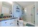 Bathroom featuring a granite-topped vanity, shower, and a decorative seahorse statue at 2300 N Atlantic Ave # 203, Daytona Beach, FL 32118