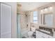 Bright bathroom featuring a shower-tub combination and granite vanity at 2300 N Atlantic Ave # 203, Daytona Beach, FL 32118