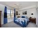Comfortable bedroom featuring a queen bed, large window with curtains, and stylish decor for relaxation at 2300 N Atlantic Ave # 203, Daytona Beach, FL 32118