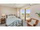 Bright bedroom with a stylish bed, a private balcony, and a charming wicker chair adding a cozy touch at 2300 N Atlantic Ave # 203, Daytona Beach, FL 32118