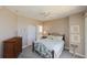 Cozy bedroom with a comfortable bed, a dresser, and an ensuite bathroom with ample natural light at 2300 N Atlantic Ave # 203, Daytona Beach, FL 32118