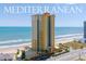 Oceanfront Mediterranean condo with private balconies and palm-lined entrance at 2300 N Atlantic Ave # 203, Daytona Beach, FL 32118