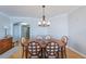 Charming dining room boasts a wooden table and unique light fixture at 2300 N Atlantic Ave # 203, Daytona Beach, FL 32118