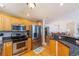 Bright kitchen featuring stainless steel appliances, granite countertops, and wooden cabinets at 2300 N Atlantic Ave # 203, Daytona Beach, FL 32118