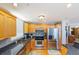 Kitchen with stainless steel appliances, light wood cabinetry, granite countertops, and modern lighting at 2300 N Atlantic Ave # 203, Daytona Beach, FL 32118