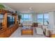 Bright living room with ocean views, wood entertainment center, and comfortable seating arrangement at 2300 N Atlantic Ave # 203, Daytona Beach, FL 32118