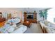 Open living room with large entertainment center, comfortable seating, and adjacent dining area at 2300 N Atlantic Ave # 203, Daytona Beach, FL 32118