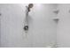 Tiled shower showcasing modern shower head and wall shelving at 2300 N Atlantic Ave # 203, Daytona Beach, FL 32118