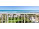 Breathtaking ocean view from the balcony surrounded by lush greenery and palm trees in a tranquil setting at 2300 N Atlantic Ave # 203, Daytona Beach, FL 32118