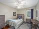Cozy bedroom featuring a bed, side tables, and a window providing natural light at 2338 Tuscarora Trl, Maitland, FL 32751