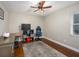 This bedroom features wood floors, a ceiling fan, and a large window at 2338 Tuscarora Trl, Maitland, FL 32751