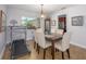 Bright dining area with a table and seating for six, complemented by tile flooring and natural light at 2338 Tuscarora Trl, Maitland, FL 32751