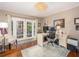 Home office bathed in natural light, featuring hardwood floors, desk, and french doors to the outside at 2338 Tuscarora Trl, Maitland, FL 32751