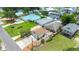 This aerial view shows the proximity to the water, as well as multiple buildings and lush green grass at 235 Randle Ave, Oak Hill, FL 32759