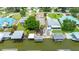 This aerial view shows the home's dock, boats, landscaping and multiple dwellings, including a green roof at 235 Randle Ave, Oak Hill, FL 32759