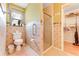 Bathroom featuring a walk-in shower, toilet, and towel rack at 235 Randle Ave, Oak Hill, FL 32759