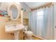 Bathroom featuring pedestal sink, toilet and bathtub shower at 235 Randle Ave, Oak Hill, FL 32759