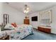 Bedroom featuring queen bed, ceiling fan, and dresser with mounted television at 235 Randle Ave, Oak Hill, FL 32759