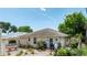 Charming single story home with landscaping, mature trees, and brick walkway, with a covered porch and table at 235 Randle Ave, Oak Hill, FL 32759