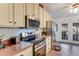 Traditional kitchen featuring stainless steel appliances, lots of storage, and views to the lanai at 235 Randle Ave, Oak Hill, FL 32759