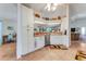The kitchen features white cabinetry, a dishwasher, tile floors and breakfast nook, along with access to the living room at 235 Randle Ave, Oak Hill, FL 32759