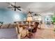 This spacious living room features lots of seating and a large wall clock and transitions to the dining room at 235 Randle Ave, Oak Hill, FL 32759