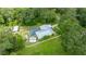 An elevated perspective featuring a pool and fencing and expansive lawn at 2360 Mooneyham Dr, New Smyrna Beach, FL 32168