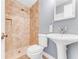 Cozy bathroom with step-in shower featuring neutral tile, gray walls and pedestal sink at 2360 Mooneyham Dr, New Smyrna Beach, FL 32168