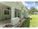 Exterior showcasing a generator and a covered outdoor area with a ceiling fan on a bright, sunny day at 2360 Mooneyham Dr, New Smyrna Beach, FL 32168
