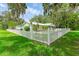 Well maintained single story home featuring a white picket fence and luscious green lawn at 2360 Mooneyham Dr, New Smyrna Beach, FL 32168