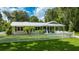 Well maintained single story home with a white picket fence and luscious green lawn at 2360 Mooneyham Dr, New Smyrna Beach, FL 32168
