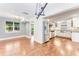 Open-concept living space with hardwood floors, stainless appliances, and a bright airy atmosphere, seamlessly blending style and function at 2360 Mooneyham Dr, New Smyrna Beach, FL 32168