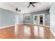 Spacious living room with hardwood floors, multiple ceiling fans, and French doors to the back yard at 2360 Mooneyham Dr, New Smyrna Beach, FL 32168