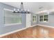 Bright and airy living room with hardwood floors and a fresh coat of paint, creating a welcoming and comfortable atmosphere at 2360 Mooneyham Dr, New Smyrna Beach, FL 32168