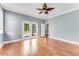 Large living room featuring hardwood floors, crown molding, and French doors leading to the pool area at 2360 Mooneyham Dr, New Smyrna Beach, FL 32168
